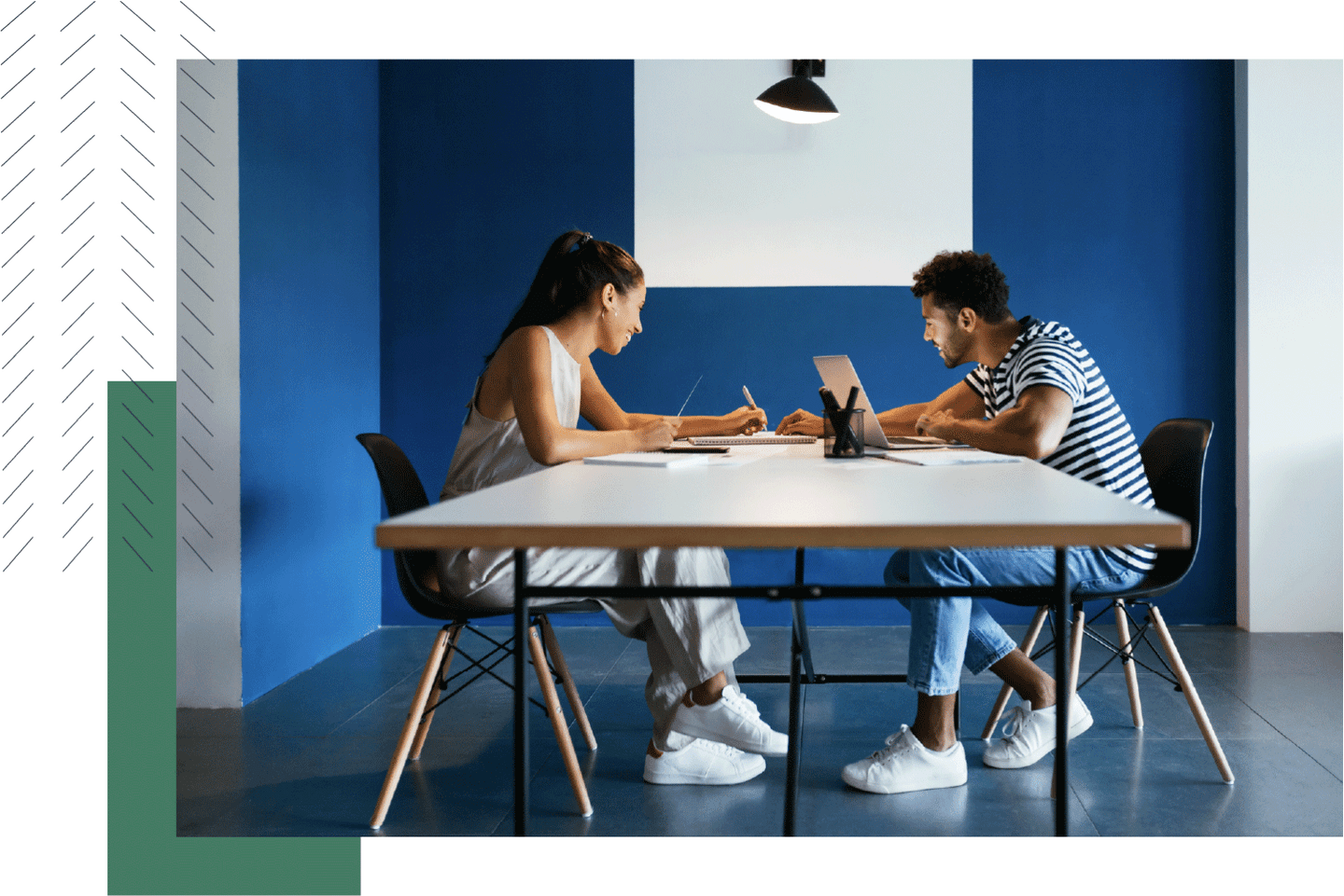 Two people working together to solve an issue in a blue office