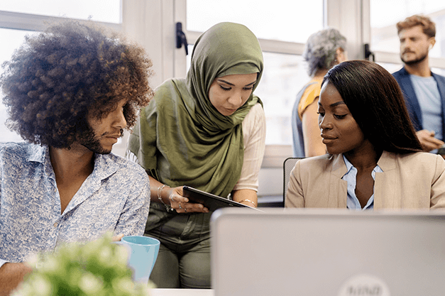 three people talking infront of a computer