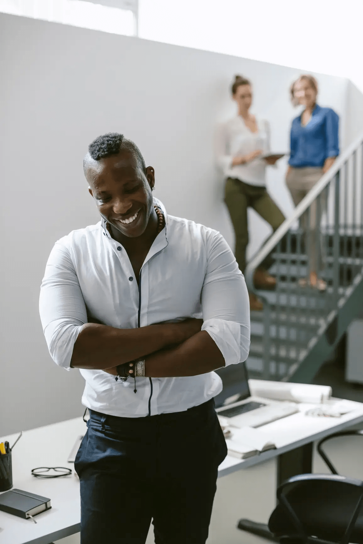 Smiling man with his arms crossed