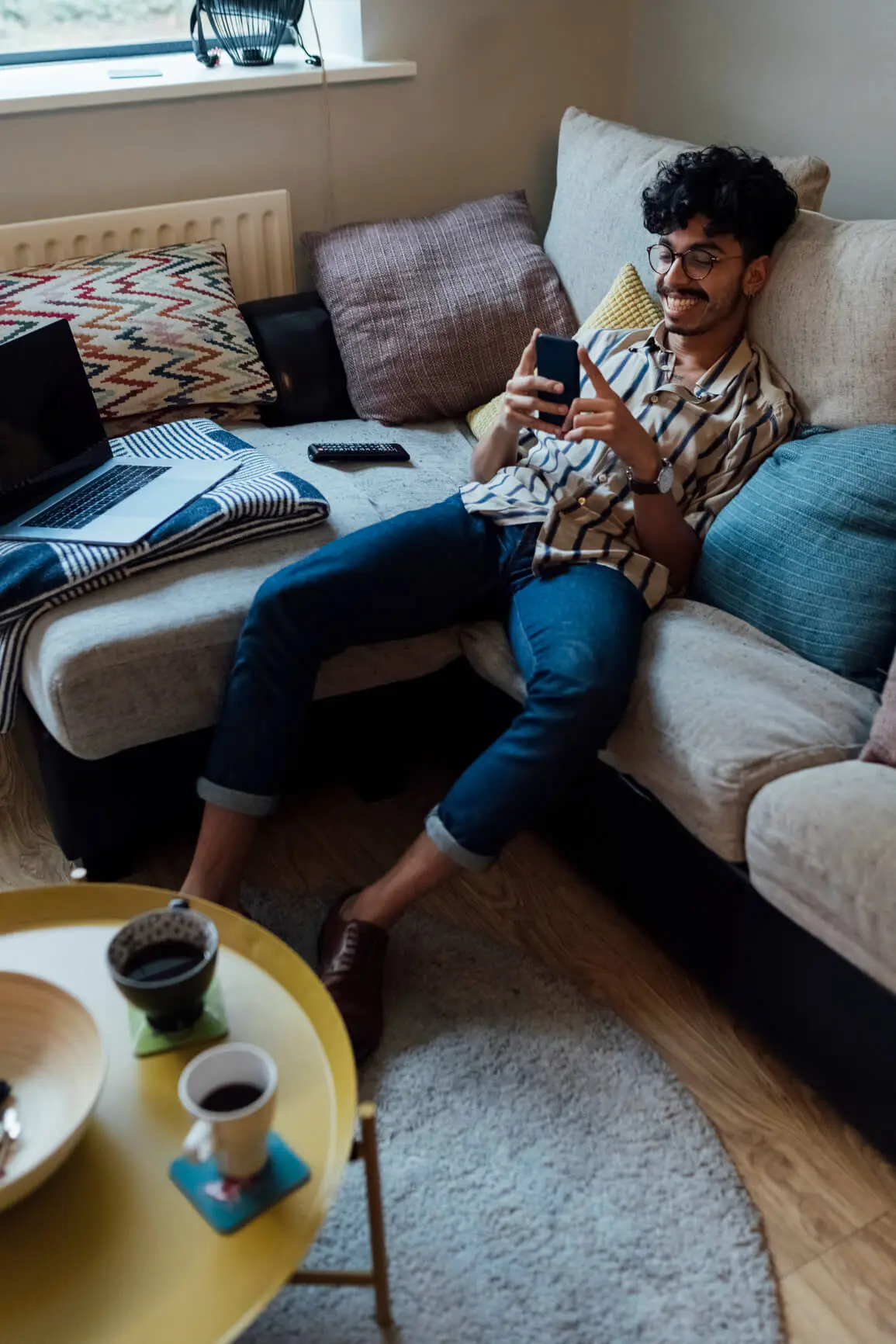 man smiling at phone while browsing wordpress themes