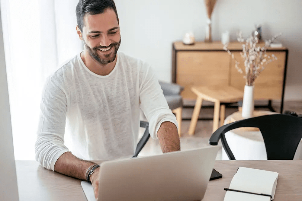 Guy smiling at laptop
