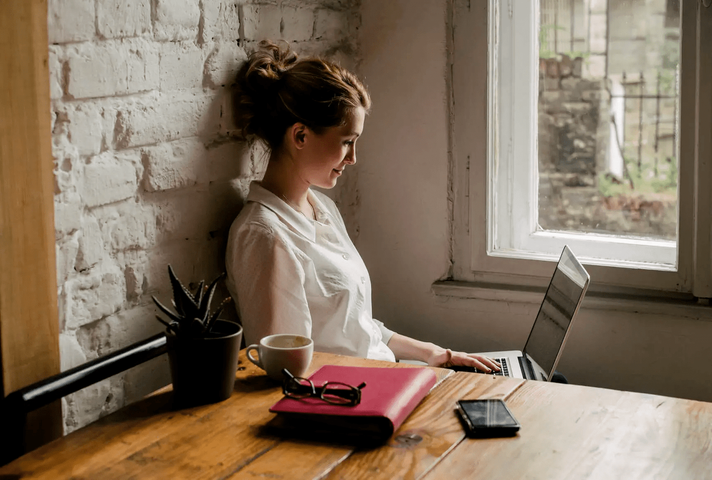 Woman looking and smiling at laptop