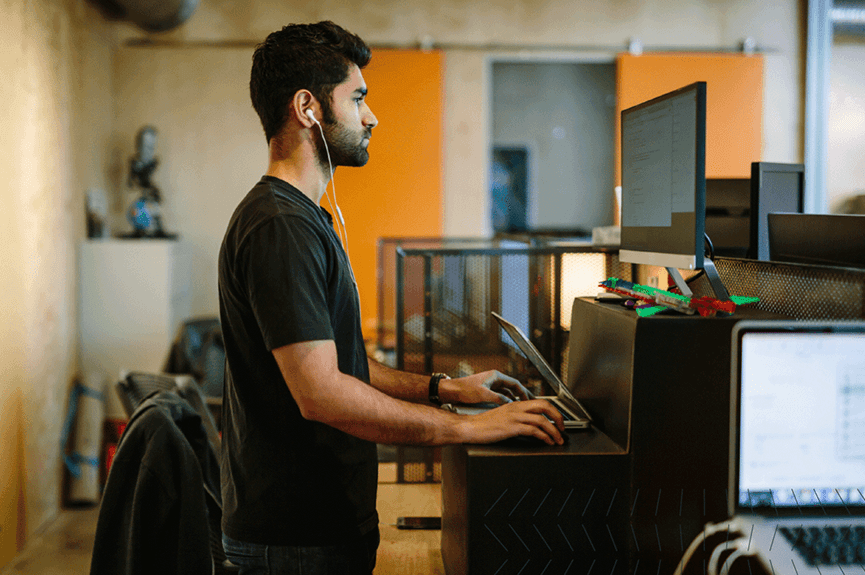 Man at standing desk working hard