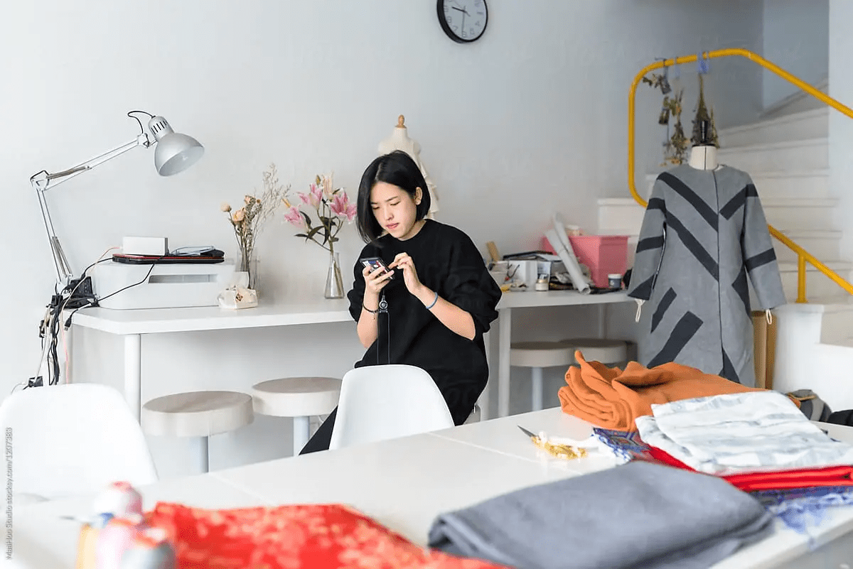 A woman typing on laptop in her business