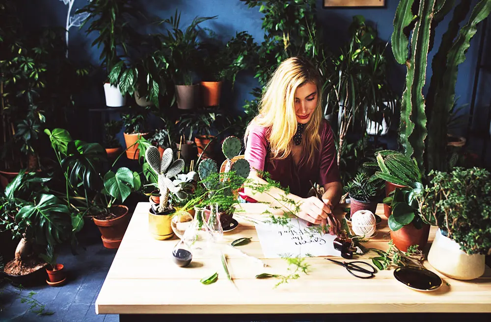 Woman arranging plants, not worrying about her businesses website security