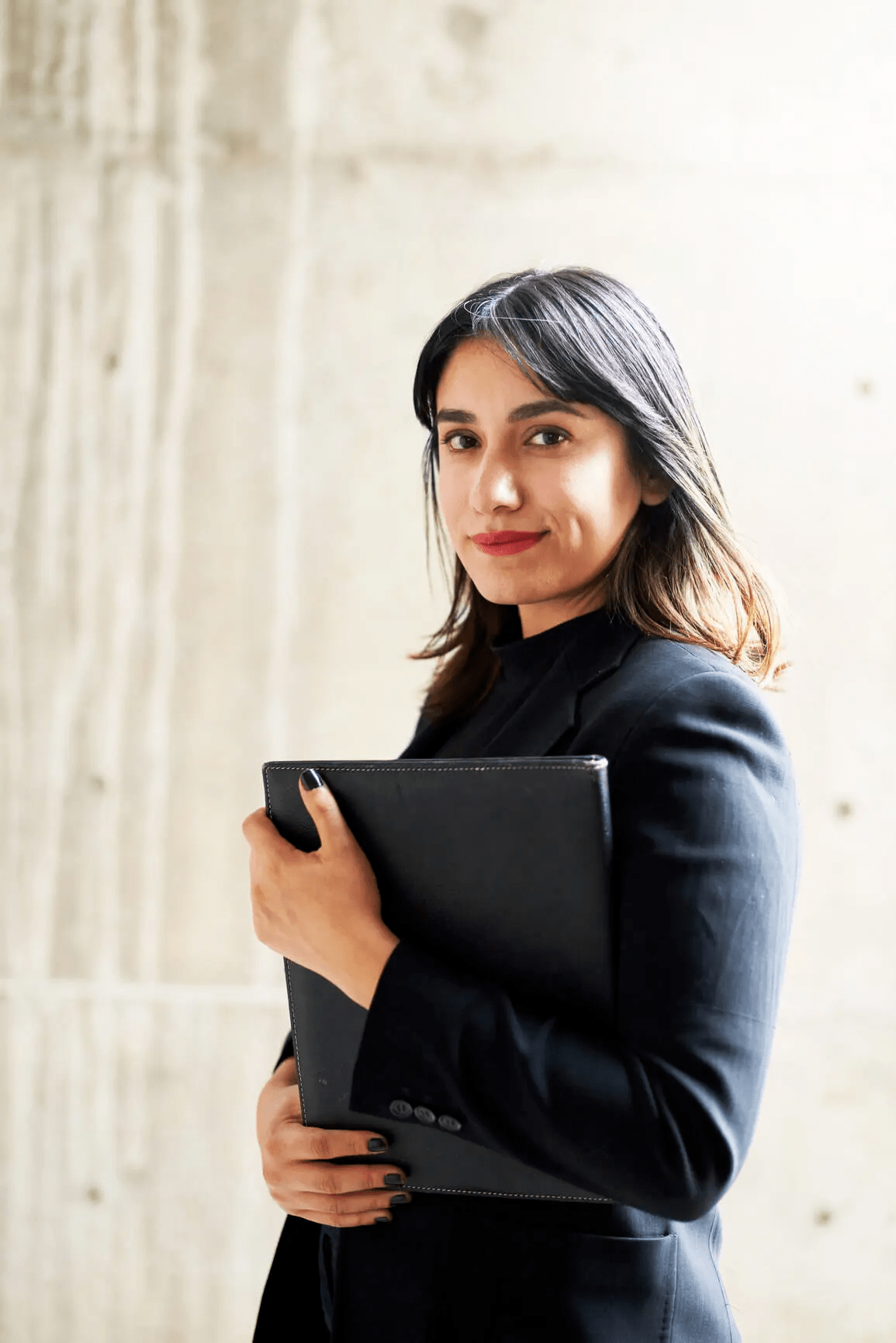 Woman holding portfolio smiling