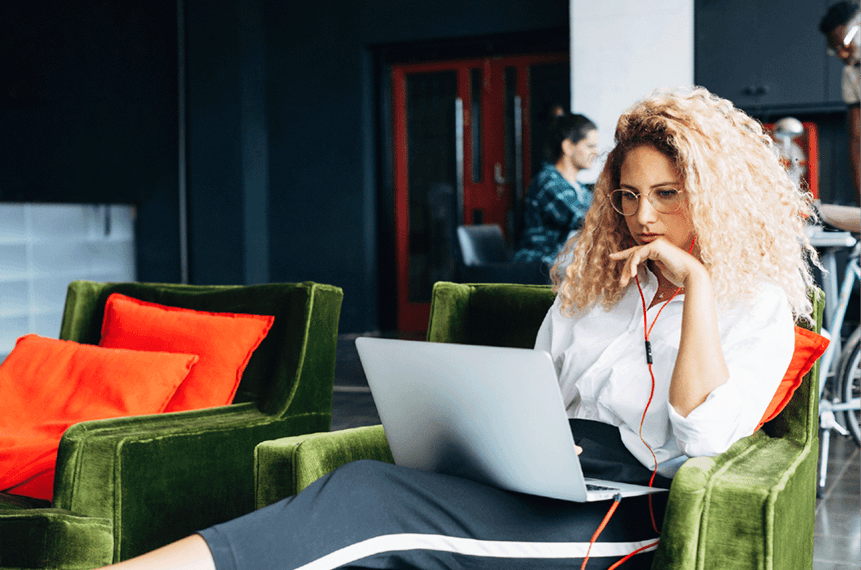 Woman sitting on a couch working hard